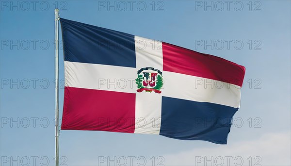 The flag of the Dominican Republic flutters in the wind, isolated against a blue sky
