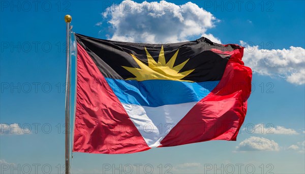 The flag of Antigua flutters in the wind, isolated against the blue sky