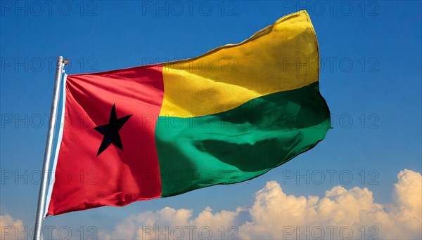 The flag of Guinea-Bissau, fluttering in the wind, isolated, against the blue sky