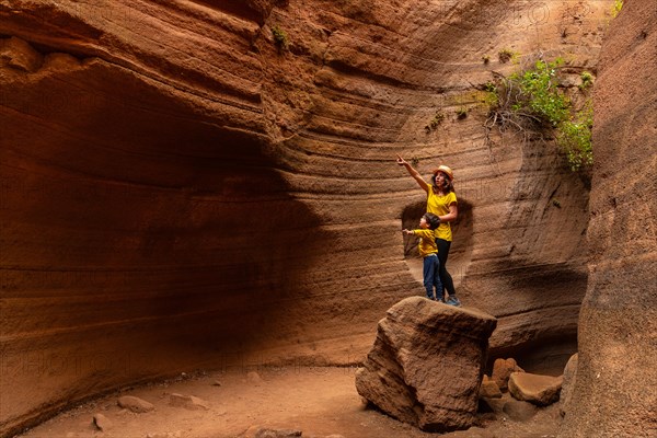 Mother and son enjoying in the limestone canyon Barranco de las Vacas in Gran Canaria, Canary Islands