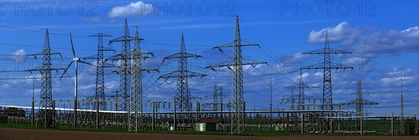 Power pylons with high-voltage lines and wind turbines at the Avacon substation in Helmstedt, Helmstedt, Lower Saxony, Germany, Europe