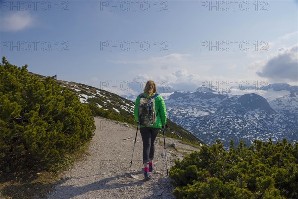 Tourist woman trekking on Mount Krippenstein in the Dachstein Mountains of Upper Austria, Salzkammergut region, Austria, Europe