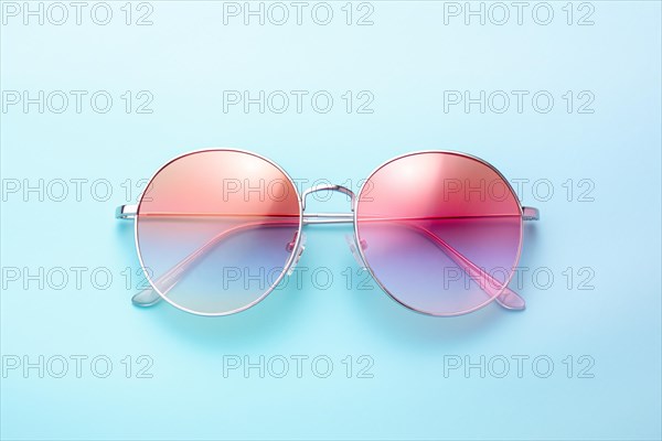 Rainbow colored sunglasses on blue background. KI generiert, generiert, AI generated