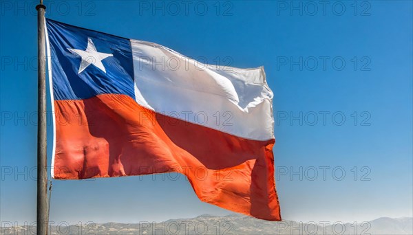 The flag of Chile flutters in the wind, isolated against a blue sky