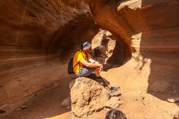 A man in the limestone canyon Barranco de las Vacas on Gran Canaria, Canary Islands