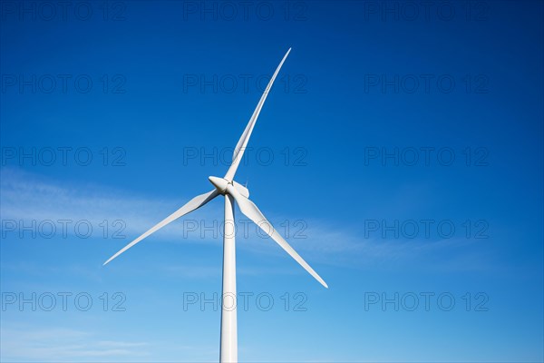 Renewable energy windmill turbine in front of blue sky. KI generiert, generiert, AI generated