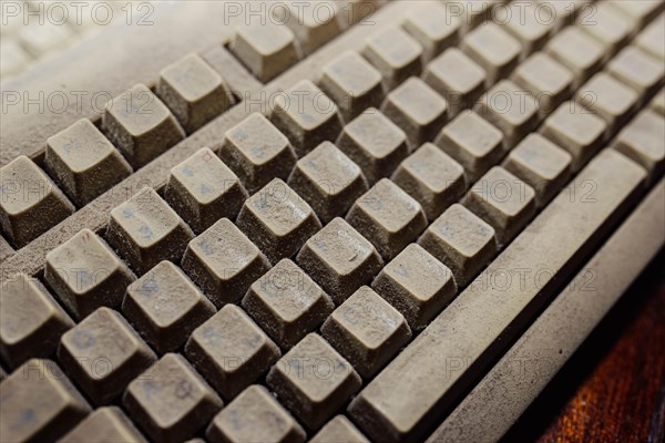 Old vintage computer mechanical keyboard in dust, computer keyboard from the 1980s