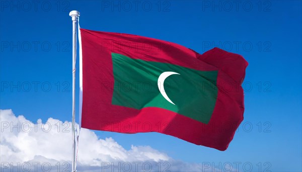 The flag of Maldives, fluttering in the wind, isolated, against the blue sky