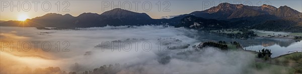 Aerial view, lake in fog in front of mountains, sunrise, backlight, panorama, summer, Lake Kochel and Kochler mountains, Alpine foothills, Bavaria, Germany, Europe