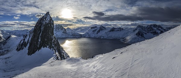 Aerial view of Bergen by the sea, fjord, sunbeams, winter, snow, panorama, Mount Segla, Senja, Troms, Norway, Europe