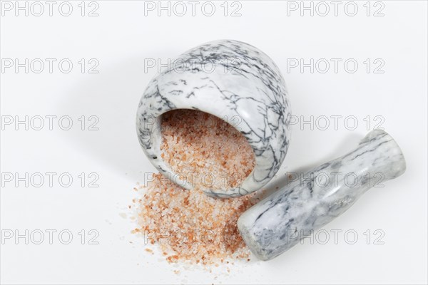 Himalayan pink salt in a ceramic mortar isolated on white background and copy space