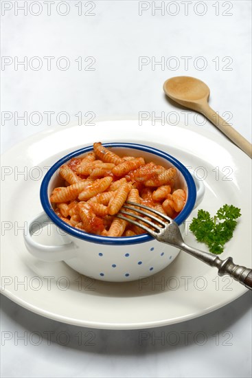 Malloreddus, Sardinian gnocchetti with tomato sauce in a bowl, traditional pasta variety from Sardinia, Italy, Europe