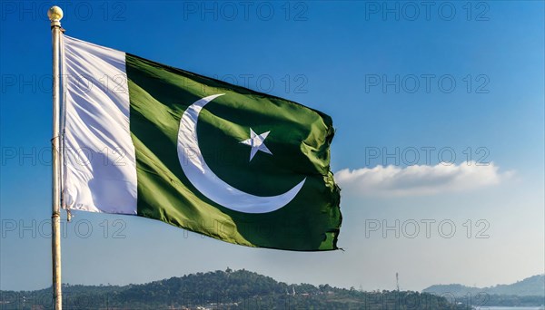 The flag of Pakistan flutters in the wind, isolated against a blue sky