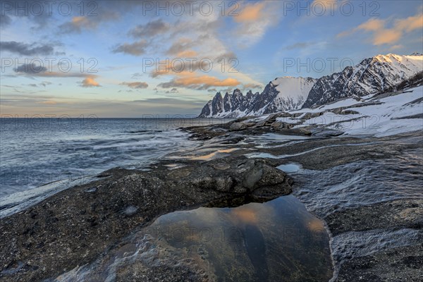 Rocky coast in front of Bergen, sea and pond, morning mood with clouds, winter, Tungeneset, Senja, Troms, Norway, Europe