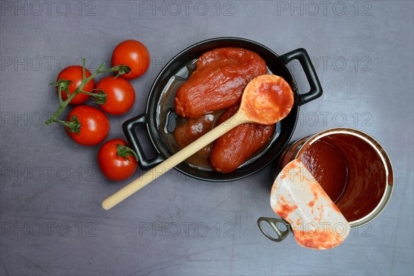 Whole tinned tomatoes in a pot, tomatoes and tins