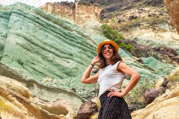 Portrait of a woman at the natural monument at the Azulejos de Veneguera or Rainbow Rocks in Mogan, Gran Canaria