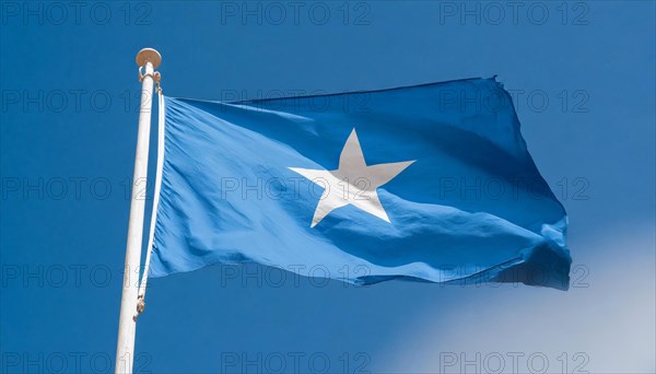 The flag of Somalia, fluttering in the wind, isolated, against the blue sky