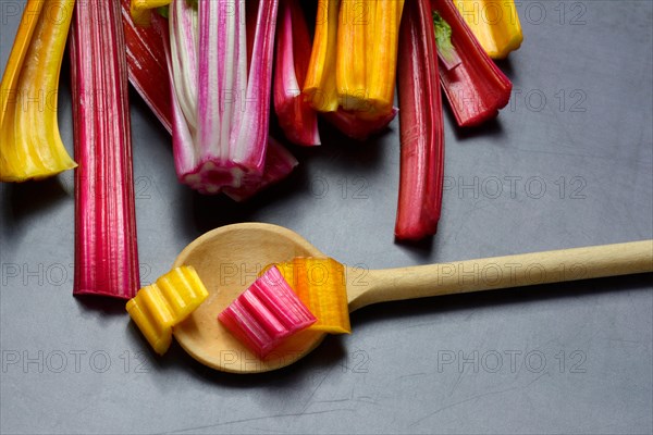 Red and yellow chard, wooden spoon and chopped stems, Beta vulgaris
