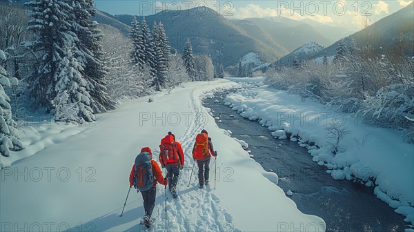 Snowshoers traveling alongside a river in a beautiful snow-covered landscape with winter trees and mountains, AI generated