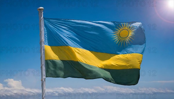 The flag of Rwanda, fluttering in the wind, isolated, against the blue sky