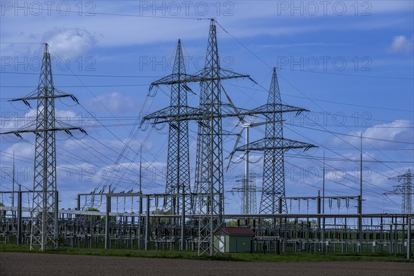 Power pylons with high-voltage lines and wind turbine at the Avacon substation in Helmstedt, Helmstedt, Lower Saxony, Germany, Europe