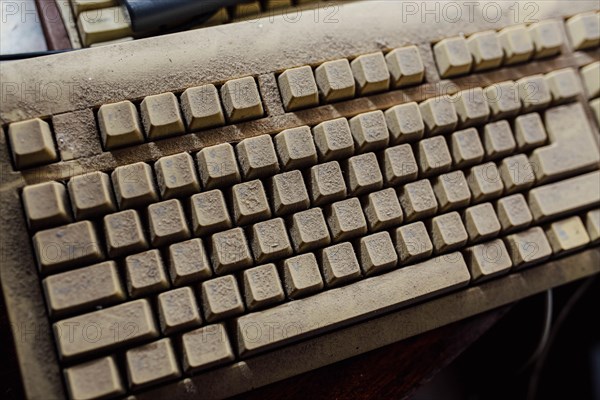 Old vintage computer mechanical keyboard in dust, computer keyboard from the 1980s