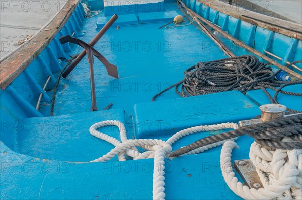 Rope and anchor in boat dry docked on concrete quay in South Korea
