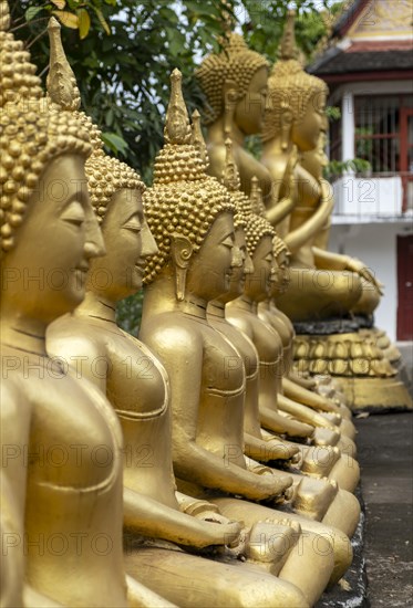 Row of golden Buddha images, Wat That Luang temple, Luang Prabang, Laos, Asia