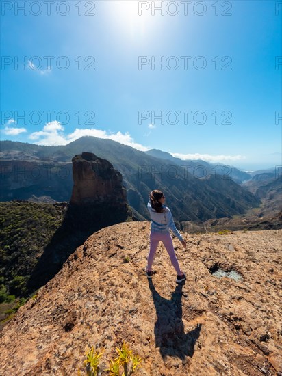 A woman tourist at the Roque Palmes viewpoint near Roque Nublo in Gran Canaria, Canary Islands