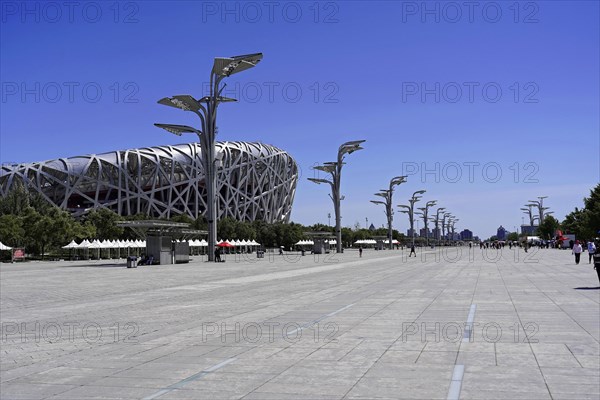 Beijing, China, Asia, Wide perspective of an empty square with a stadium in the background under a clear blue sky, Asia