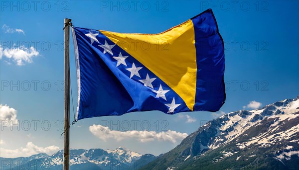 The flag of Bosnia and Herzegovina flutters in the wind, isolated against a blue sky