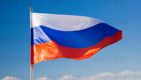 The flag of Russia flutters in the wind, isolated against a blue sky