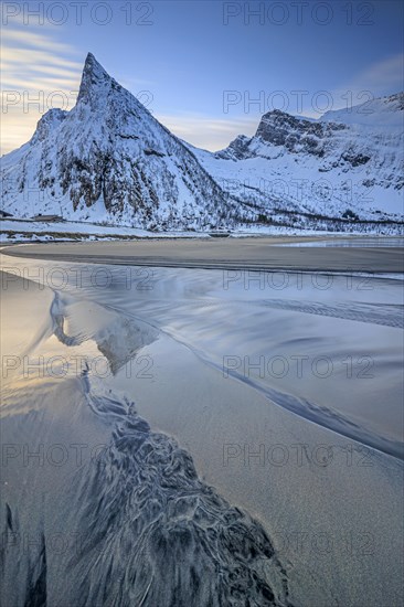 Steep mountain reflected in the water on the beach, coast, morning mood with clouds, winter, Senja, Troms, Norway, Europe