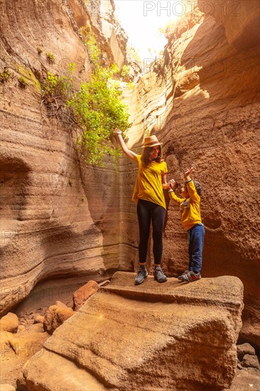 Family on vacation in the limestone canyon Barranco de las Vacas on Gran Canaria, Canary Islands