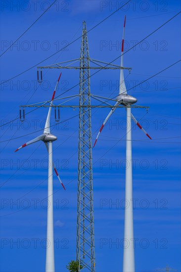 Power pylon with high-voltage lines and wind turbines at the Avacon substation Helmstedt, Helmstedt, Lower Saxony, Germany, Europe