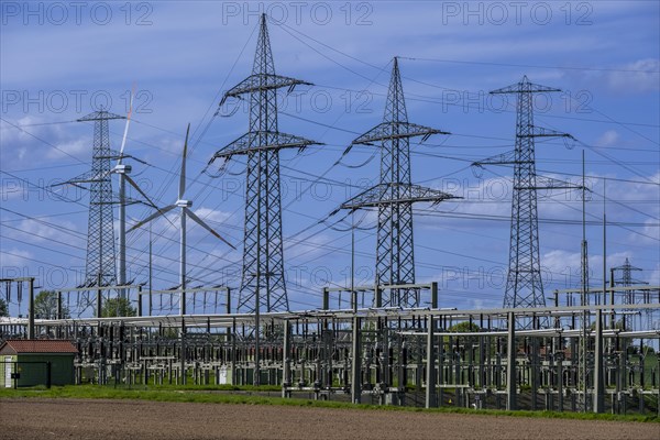 Power pylons with high-voltage lines and wind turbines at the Avacon substation in Helmstedt, Helmstedt, Lower Saxony, Germany, Europe