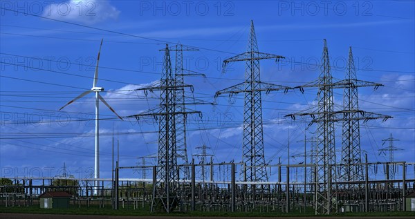 Wind turbine and high-voltage pylons at the Avacon substation in Helmstedt, Helmstedt, Lower Saxony, Germany, Europe