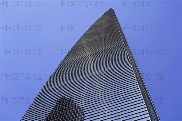 The 632 metre high Shanghai Tower, nicknamed The Twist, Shanghai, People's Republic of China, A skyscraper with a gleaming glass facade and sharp shadows cast under a blue sky, Shanghai, China, Asia