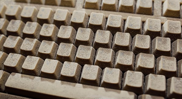 Old vintage computer mechanical keyboard in dust, computer keyboard from the 1980s