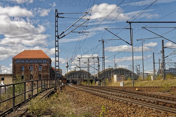 In the foreground, the railway tracks and Postbahnhof Berlin building and the Ostbahnhof station concourse 2015, Berlin