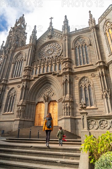 A mother with her son visiting the Church of San Juan Bautista, Arucas Cathedral, Gran Canaria, Spain, Europe