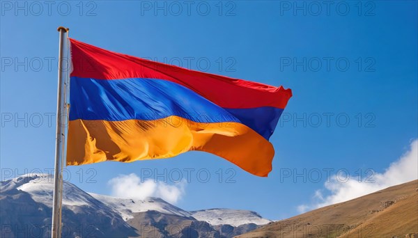 The flag of Armenia flutters in the wind, isolated against a blue sky