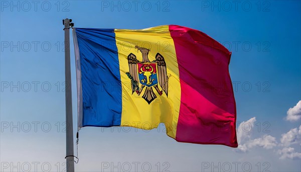 The flag of Moldova, Republic of Moldova, flutters in the wind, isolated against a blue sky