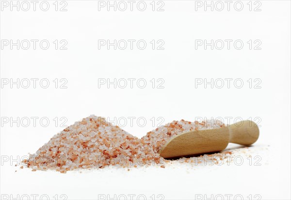 Wooden spoon with pink himalayan salt isolated on white background and copy space