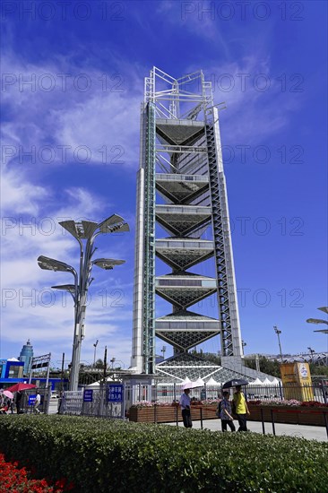 Beijing, China, Asia, High Tower under blue sky next to modern streetlights and people on the ground, Asia