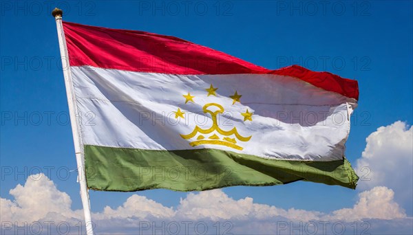 The flag of Tajikistan, fluttering in the wind, isolated, against the blue sky