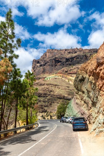 Beautiful road under the natural monument at the Azulejos de Veneguera or Rainbow Rocks in Mogan, Gran Canaria