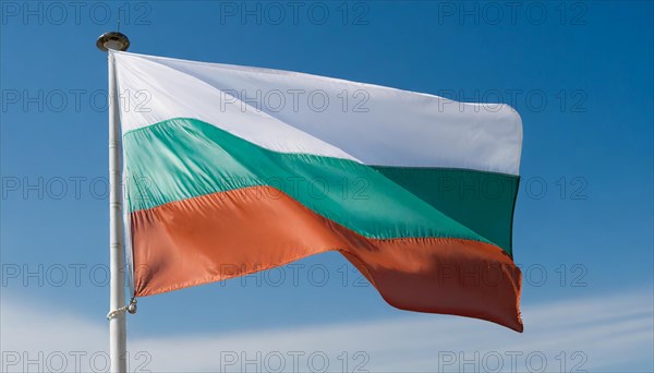 The flag of Bulgaria flutters in the wind, isolated against a blue sky