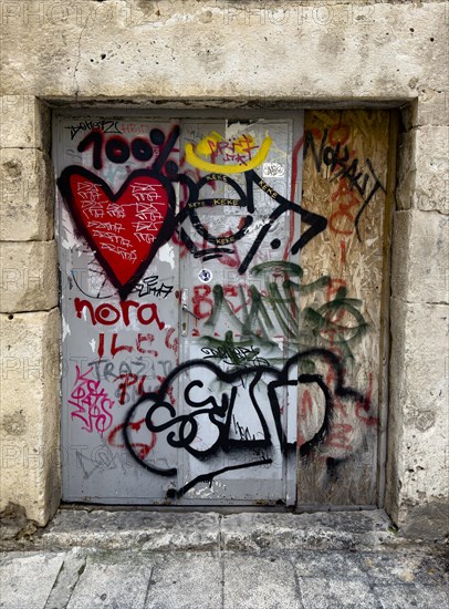 Heavy door full of graffiti and tags in an old city wall, Split, Dalmatia, Croatia, Europe