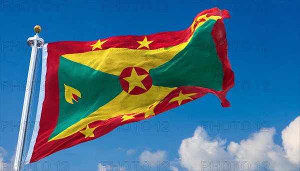 The flag of Grenada, Caribbean, flutters in the wind, isolated, against the blue sky